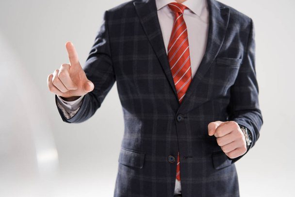 cropped view of young businessman pointing on grey - Fotoğraf, Görsel