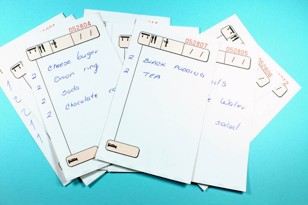 close-up shot of restaurant check lists on blue background - Foto, immagini