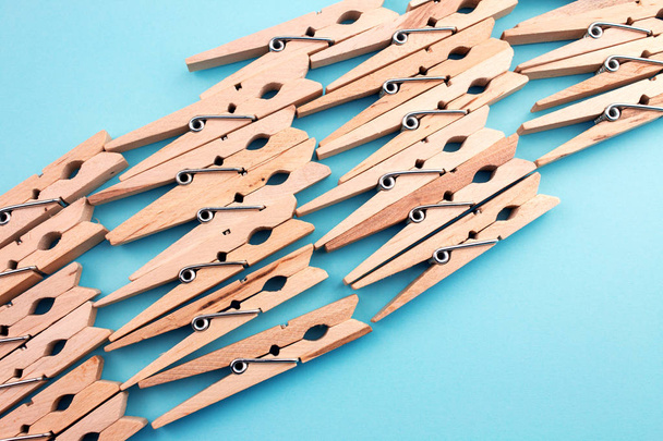 top view of wooden clothespins on blue background - Photo, Image