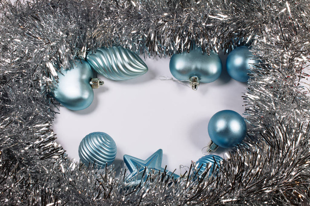 Christmas silver Tinsel and blue Balls isolated on white background - Φωτογραφία, εικόνα