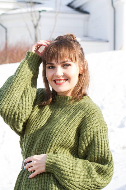 Girl in a warm green sweater. Winter - Fotó, kép