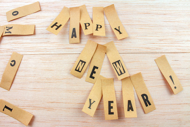 close-up shot of words happy new year made with stickers attached on wooden surface - Photo, Image