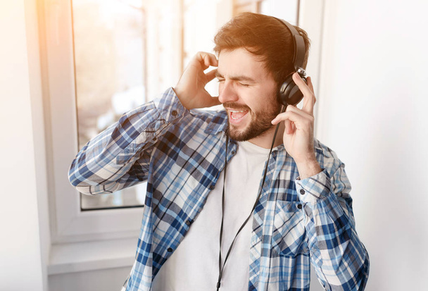 Bearded man in headphones singing with music  - Fotoğraf, Görsel