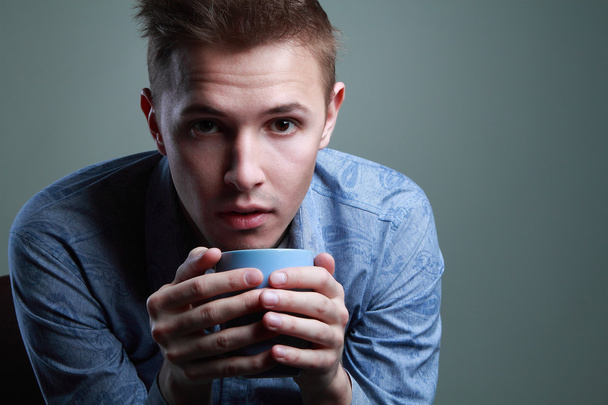 "guy gets warm with a cup of coffee" - Photo, Image