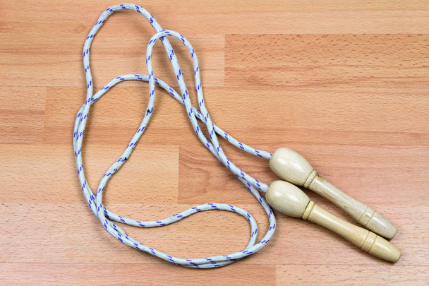 close-up shot of jumping rope on wooden floor - Photo, Image