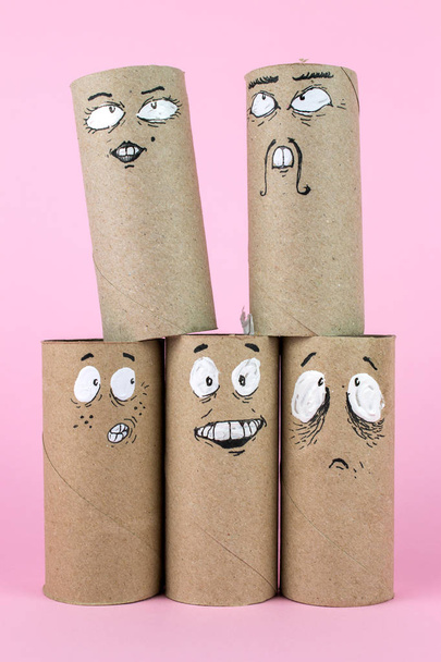 Recycled Bathroom Rolls with Emotional Painted Faces isolated on pink - Photo, Image