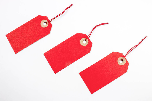 red paper tags tied with strings isolated on white - Photo, Image