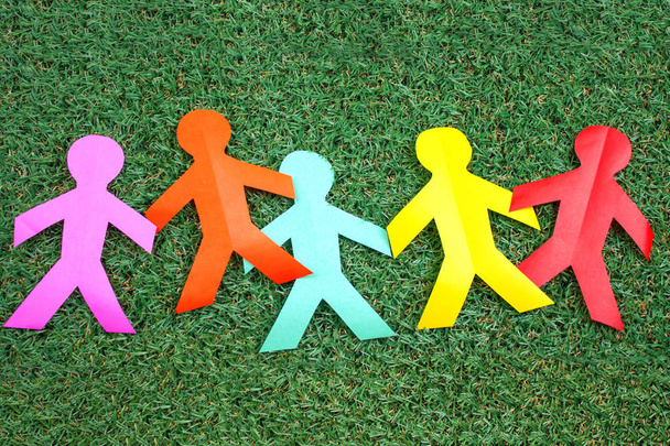 colorful paper people on green grass background - Foto, Imagem