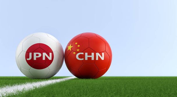 China vs. Japan Soccer Match - Soccer balls in Chinas and Japans national colors on a soccer field. Copy space on the right side - 3D Rendering  - Fotoğraf, Görsel