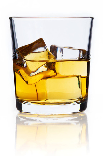 Glass of whiskey with ice cubes (on the rocks) isolated on white background - Fotografie, Obrázek