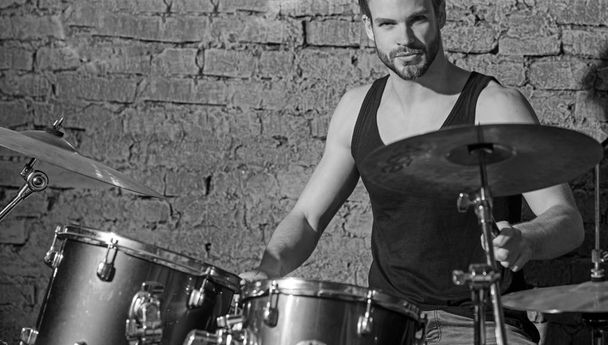 Heartbeat of the band. Man drummer playing musical instrument. Handsome man play percussion instrument. Rock concert or rehearsal in music club. Enjoying instrumental music. Rock star or rocker - Foto, Bild