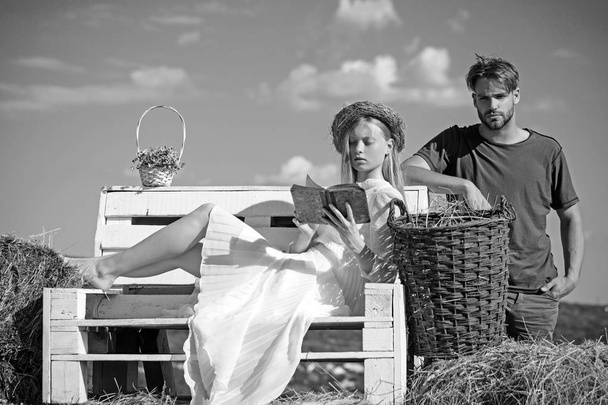 Girlfriend and boyfriend date outdoor. Woman bride in wedding dress relax on bench. Sensual woman read book for man. Couple in love on vacation. Family enjoy summer nature - Fotoğraf, Görsel