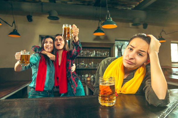 Sport, people, leisure, friendship and entertainment concept - happy football fans or female friends drinking beer and celebrating victory at bar or pub - Zdjęcie, obraz