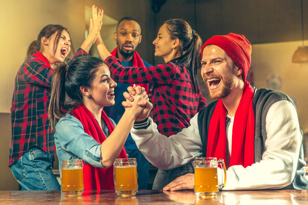 Sport, people, leisure, friendship and entertainment concept - happy football fans or male friends drinking beer and celebrating victory at bar or pub - Фото, изображение