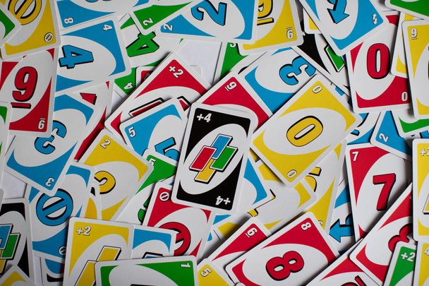 Chelybinsk, Russia - December 25, 2018: Deck of Uno game cards scattered all over on a table. American card game. - 写真・画像