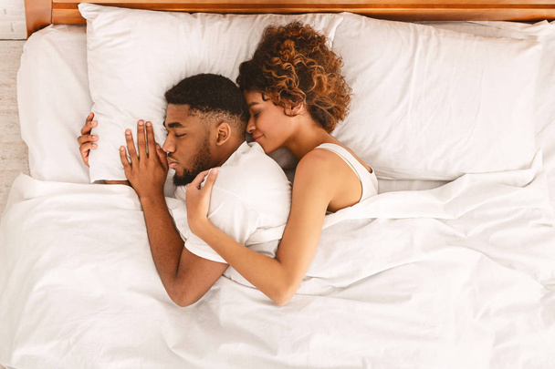 Loving couple sleeping in bed and hugging - Valokuva, kuva