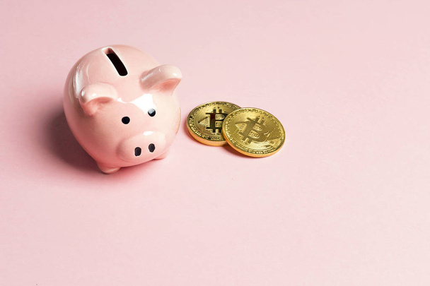 Piggybank with bitcoin on pink background. Copy space for text. - Foto, Imagen
