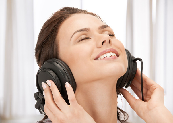 Happy teenage girl in big headphones - Фото, зображення