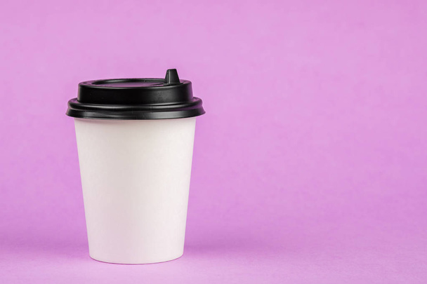 Pojemnik na kawę papierową z czarną pokrywką na fioletowym tle. Bve - Zdjęcie, obraz