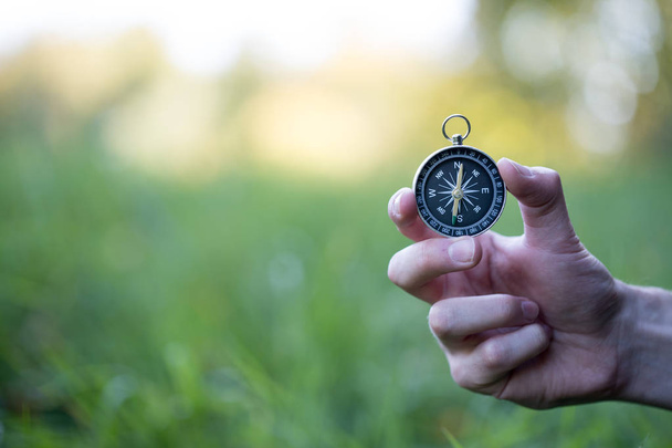 Compass holding in the hand, outdoor adventure - Фото, изображение