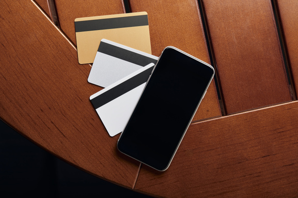 top view of credit cards and smartphone with copy space  - Foto, Imagen