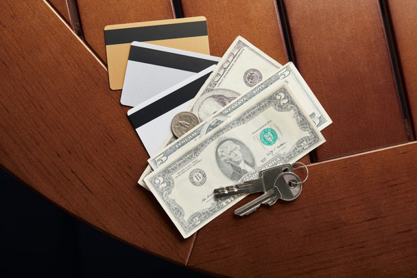 vista superior de cartões de crédito, dinheiro e chaves na tabela
  - Foto, Imagem