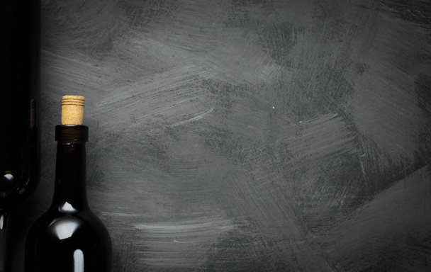 Glass bottle of wine with corks on wooden table background - Fotografie, Obrázek