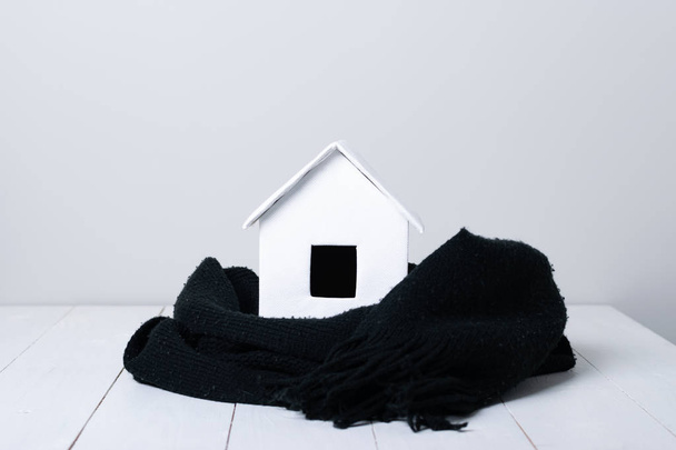 small white hut with scarf on wooden surface - Valokuva, kuva