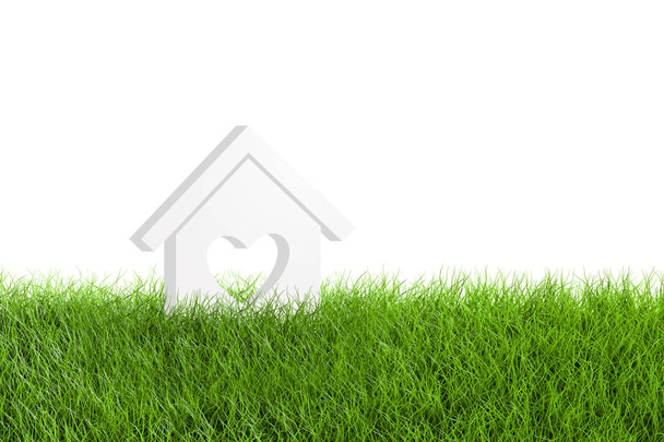 Model huisje met hart vorm op groen grasveld - Foto, afbeelding