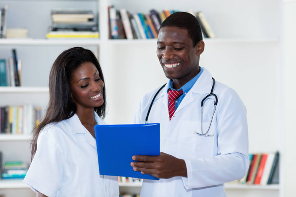 Laughing african american male and female doctor - Photo, Image