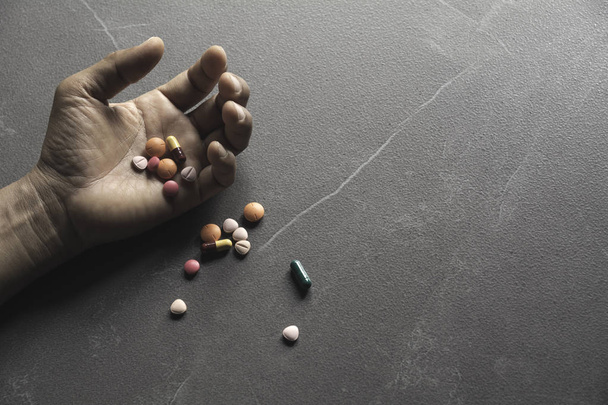 The man committing suicide by overdosing on medication. Close up - Photo, Image