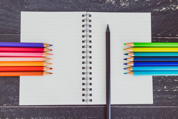 desk with notepad and colourful pencils with empty pages and cop - Fotoğraf, Görsel