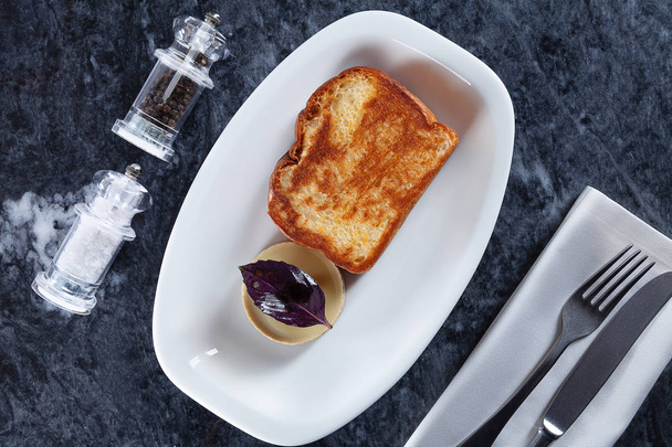 Top view on traditional breakfast food. European cuisine. Fried toast with pate on white plate on marble table overhead. Picture for design with copy space. Flat lay - Foto, imagen