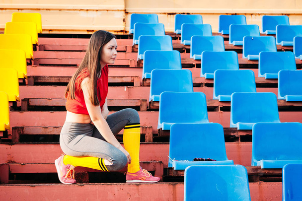 Sexy sport girl posing at stadium. Fitness girl with sports figu - Foto, imagen