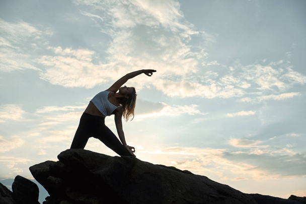 Woman Practicing Yoga in the Nature. Meditating Outdoors - Фото, зображення