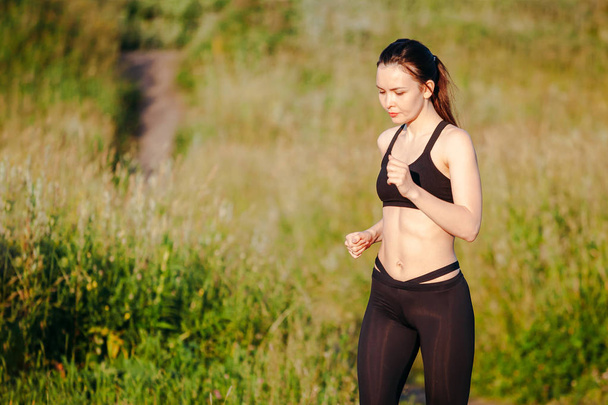 young sports woman engaged in summer morning running in Park. in - Foto, imagen