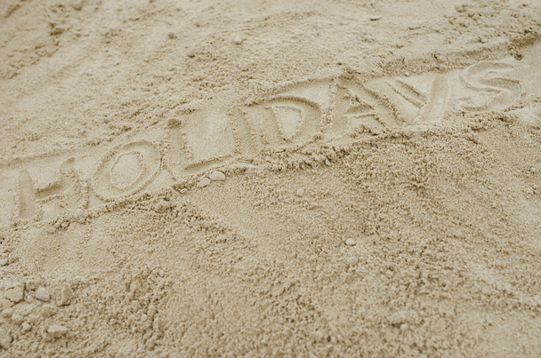 Word holidays written on sandy beach - Φωτογραφία, εικόνα