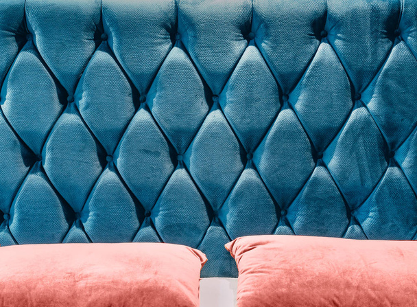Couch-type velours screed on headboard tightened with buttons. Blue chesterfield style quilted upholstery backdrop close up. Capitone pattern texture background - Photo, Image