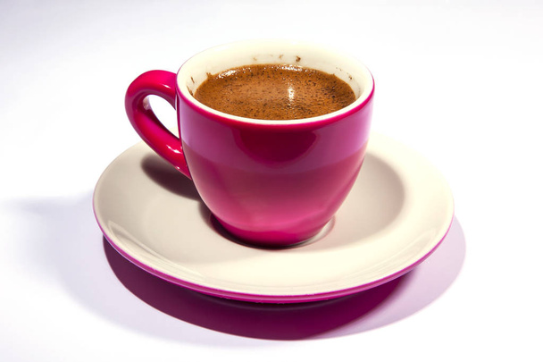 Espresso coffee in a bright pink porcelain cup on the table - Foto, Imagem