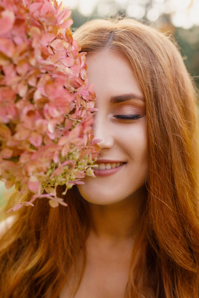 beautiful young woman with long hair in a wreath of flowers - Foto, Bild