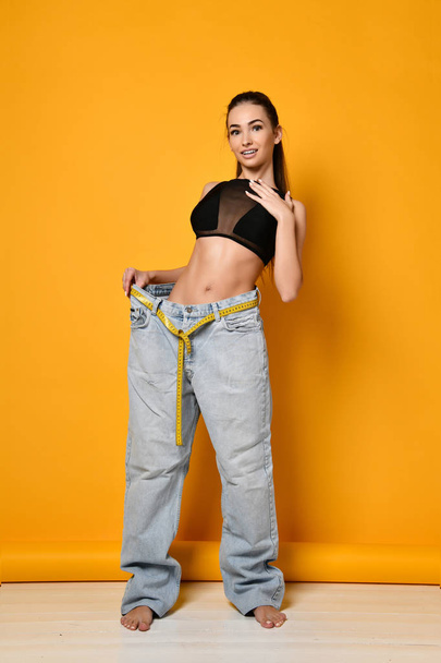 beautiful young woman with big jeans - Fotó, kép