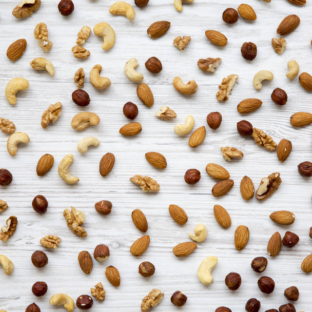 Mixed nuts (cashew, hazelnuts, walnuts, almonds) on white wooden - Photo, Image