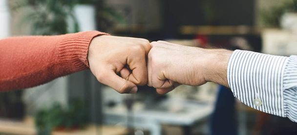 Male friends greeting each other with fist bump - Photo, Image