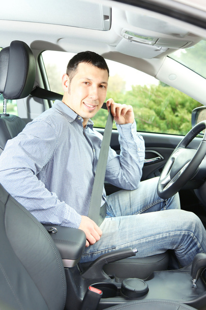 Portrait of young man sitting in the car - Photo, image