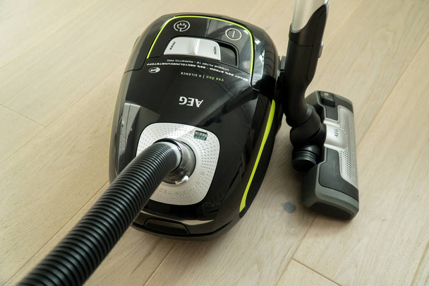 Vacuum cleaner on the wooden floor. Cleaning home - Fotó, kép