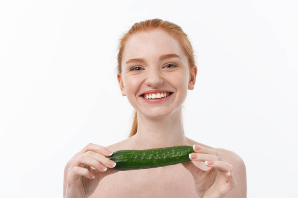 Cheerful happy beautiful girl with cucumber on her hand - isolated on white - Photo, Image