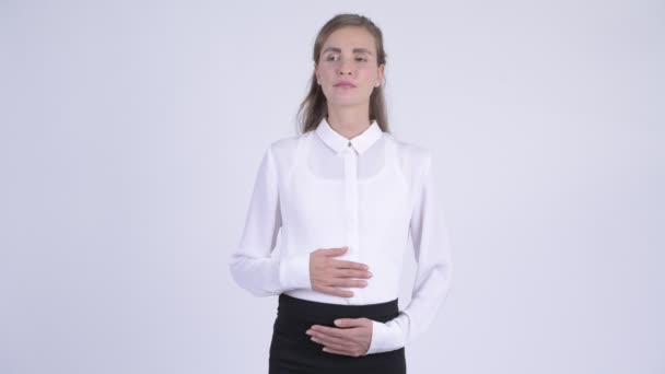 Young beautiful pregnant businesswoman thinking and waiting - Materiał filmowy, wideo