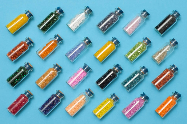 Colored beads in special glass jars. Female or kids hobby - 写真・画像