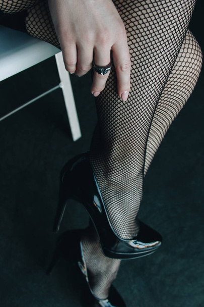 Woman legs in black stockings and high heels shoes - 写真・画像