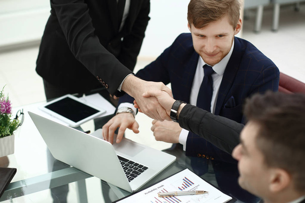 financial partners handshakes over a Desk in the office - Photo, Image